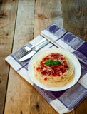 Spaghetti Pasta with Tomato Sauce, Cheese and Basil on Wooden Table. Traditional Italian Food stock image Spaghetti Pasta with Tomato Sauce, Cheese and Basil on Wooden Table. Traditional Italian Food stock image