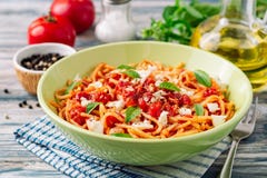 Spaghetti pasta with tomato sauce, mozzarella cheese and fresh basil leaves on white-blue vintage wooden background stock image Spaghetti pasta with tomato sauce, mozzarella cheese and fresh basil leaves on white-blue vintage wooden background stock image