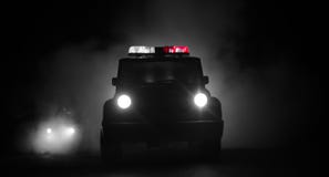 Speed lighting of police car in the night on the road. Police cars on road moving with fog. Selective focus. Chase. Speed lighting of police car in the night on stock image Speed lighting of police car in the night on the road. Police cars on road moving with fog. Selective focus. Chase. Speed lighting of police car in the night on stock image