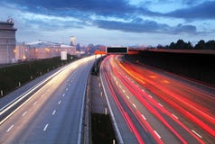 Speed Traffic at Dramatic Sundown Time - light trails on motorwa Stock Photography Speed Traffic at Dramatic Sundown Time - light trails on motorwa Stock Photography