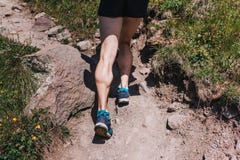 Spierkalveren van een jonge atleet die een bergweg, u lanceren stock afbeelding Spierkalveren van een jonge atleet die een bergweg, u lanceren stock afbeelding