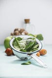 Fresh organic spinach leaves in metal colander and healthy ingre Royalty Free Stock Photography Fresh organic spinach leaves in metal colander and healthy ingre Royalty Free Stock Photography