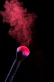 Splash of powder on a black background brushes for make up royalty free stock image Splash of powder on a black background brushes for make up royalty free stock image