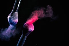 Splash of powder on a black background brushes for make up on a black background stock photography Splash of powder on a black background brushes for make up on a black background stock photography