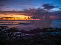 Splashing waves of stones on the background of multi-colored clouds at sunset stock image Splashing waves of stones on the background of multi-colored clouds at sunset stock image