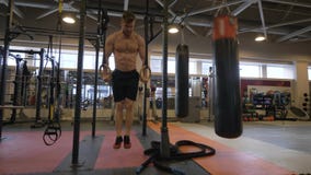 Sport man training workout exercise on gymnastic rings in fitness club stock photo Sport man training workout exercise on gymnastic rings in fitness club stock photo