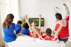 Football fans watching soccer game on tv at home Stock Photography Football fans watching soccer game on tv at home Stock Photography