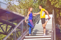 Sporty man and woman stretching legs before jog Royalty Free Stock Image Sporty man and woman stretching legs before jog Royalty Free Stock Image