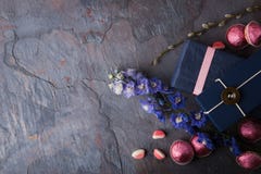 Spring gift with candy and flowers on a blue stone background Royalty Free Stock Images Spring gift with candy and flowers on a blue stone background Royalty Free Stock Images