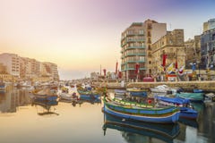 St.Julian`s, Malta - Traditional colorful Luzzu fishing boats at Spinola bay Royalty Free Stock Photo St.Julian`s, Malta - Traditional colorful Luzzu fishing boats at Spinola bay Royalty Free Stock Photo