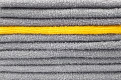 Stack of gray and yellow terry towels, conceptual background stock image Stack of gray and yellow terry towels, conceptual background stock image