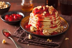 Stack Of Pancakes With Strawberry Jam And Walnuts. Tasty Dessert Stock Photography