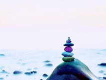 Stacked Rounded Stones At Sea. Polished Pebbles On Dark Wet Rock, Smooth Water Stock Images