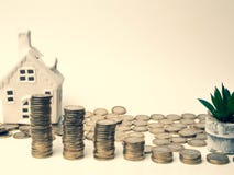 Stacking gold coins tower and house, saving money and loan for construction real estate and home concept stock photos Stacking gold coins tower and house, saving money and loan for construction real estate and home concept stock photos
