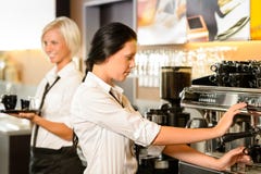 Staff at cafe making coffee espresso machine