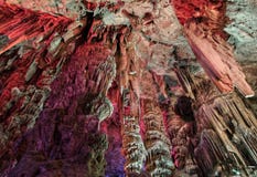 Stalactites on the ceiling of the cave red light stock images Stalactites on the ceiling of the cave red light stock images
