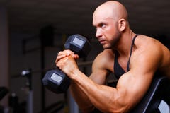 Stark riven sönder skallig man med enorma muskler som pumpar järn Sportmor royaltyfri bild Stark riven sönder skallig man med enorma muskler som pumpar järn Sportmor royaltyfri bild