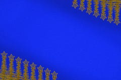 Stars on the tops of the Christmas tree, located on opposite corners of the blue background