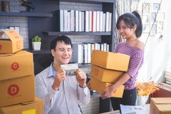 Start up team of online retailer packing boxes to send out to cu royalty free stock photos Start up team of online retailer packing boxes to send out to cu royalty free stock photos