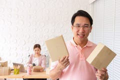Startup small business owner at home . freelance couple seller show box product order, packing goods for delivery to customer. stock photo Startup small business owner at home . freelance couple seller show box product order, packing goods for delivery to customer. stock photo