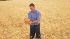 Stary średniorolny mężczyzny piekarz trzyma złotego bochenek w dojrzałym pszenicznym polu i chleb zwolnionego tempa wideo żniwo s zbiory wideo Stary średniorolny mężczyzny piekarz trzyma złotego bochenek w dojrzałym pszenicznym polu i chleb zwolnionego tempa wideo żniwo s zbiory wideo