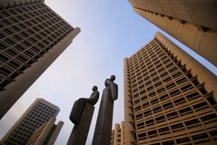 Statues Among High-rises Stock Photos