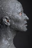 Statuesque woman in wet clay. Spa treatment. royalty free stock photos Statuesque woman in wet clay. Spa treatment. royalty free stock photos