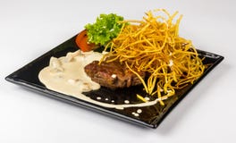 Steak With Potato Straw In Mushroom Sauce Stock Photo