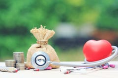 Stethoscope and red heart with money bag on green background,Saving money for Medical expenses and Health care concept royalty free stock image Stethoscope and red heart with money bag on green background,Saving money for Medical expenses and Health care concept royalty free stock image