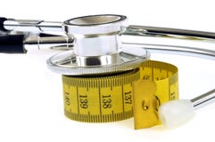Stethoscope resting on a soft seamstress meter royalty free stock photos Stethoscope resting on a soft seamstress meter royalty free stock photos