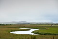 Still river among green hills in Iceland Royalty Free Stock Photo Still river among green hills in Iceland Royalty Free Stock Photo