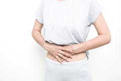 Stomach ache, women problems. Abdominal pain while sitting on bed at home. stock photo Stomach ache, women problems. Abdominal pain while sitting on bed at home. stock photo