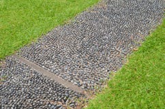 Stone paved walkway with green grass royalty free stock photos Stone paved walkway with green grass royalty free stock photos