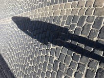 Stone street with a shadow of a woman. royalty free stock photo Stone street with a shadow of a woman. royalty free stock photo