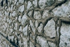 Stone wall background - building feature. Texture of thick and strong wall of rough stones of various shapes and sizes. stock images Stone wall background - building feature. Texture of thick and strong wall of rough stones of various shapes and sizes. stock images