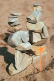 Stones lie on the stones. feng shui on the beach. Creating a balance in the sand royalty free stock photography Stones lie on the stones. feng shui on the beach. Creating a balance in the sand royalty free stock photography