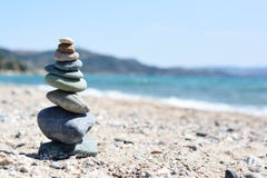 Stones pyramid on sand, beach landscape symbolizing zen and balance in life stock photography Stones pyramid on sand, beach landscape symbolizing zen and balance in life stock photography