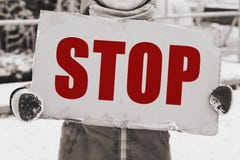 Stop child abuse in the family concept. Child with a banner in his hands and the inscription STOP stock photo Stop child abuse in the family concept. Child with a banner in his hands and the inscription STOP stock photo