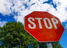 Stop traffic sign on sunny day, beautiful blue sky with white clouds stock photos Stop traffic sign on sunny day, beautiful blue sky with white clouds stock photos