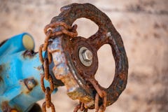 An old stopcock is secured with a rusty chain stock images An old stopcock is secured with a rusty chain stock images