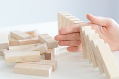 Stopping the domino effect concept with a business solution and intervention royalty free stock image Stopping the domino effect concept with a business solution and intervention royalty free stock image