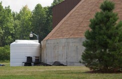 Storage tank beside building Stock Image Storage tank beside building Stock Image