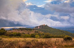 Storm clouds over medieval mountain castle stock photo Storm clouds over medieval mountain castle stock photo