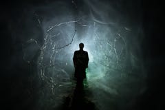 Strange Silhouette In A Dark Spooky Forest At Night, Mystical Landscape Surreal Lights With Creepy Man. Toned Stock Image Strange Silhouette In A Dark Spooky Forest At Night, Mystical Landscape Surreal Lights With Creepy Man. Toned Stock Image