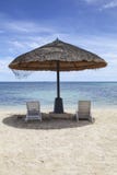 Straw Beach Umbrella con le sedie di spiaggia bianche sulla micro spiaggia in Saipan fotografia stock Straw Beach Umbrella con le sedie di spiaggia bianche sulla micro spiaggia in Saipan fotografia stock