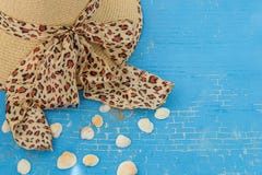Straw hat for woman with leopard print, seashells on blue background. royalty free stock photos Straw hat for woman with leopard print, seashells on blue background. royalty free stock photos