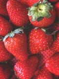 strawberries, fruit arrangement in a hazy order, in a container with a red background stock photos strawberries, fruit arrangement in a hazy order, in a container with a red background stock photos
