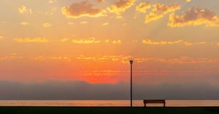 Street lamp and bench in front of the beautiful bright red sunset royalty free stock images Street lamp and bench in front of the beautiful bright red sunset royalty free stock images