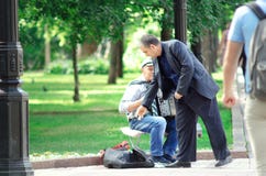 Street musician performing om the streets - People listening man playing accordion and giving char royalty free stock photo Street musician performing om the streets - People listening man playing accordion and giving char royalty free stock photo