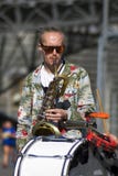 Street musician plays music. Color photo.